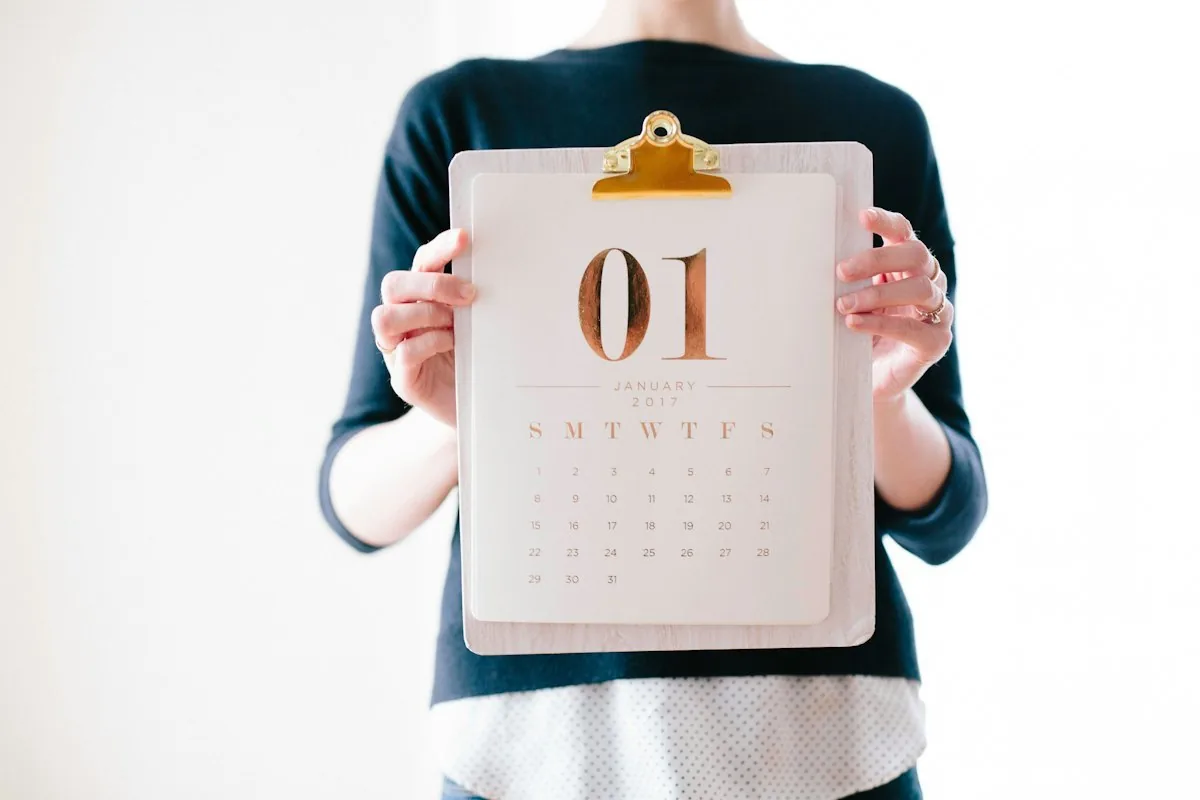 Person holding a monthly calendar