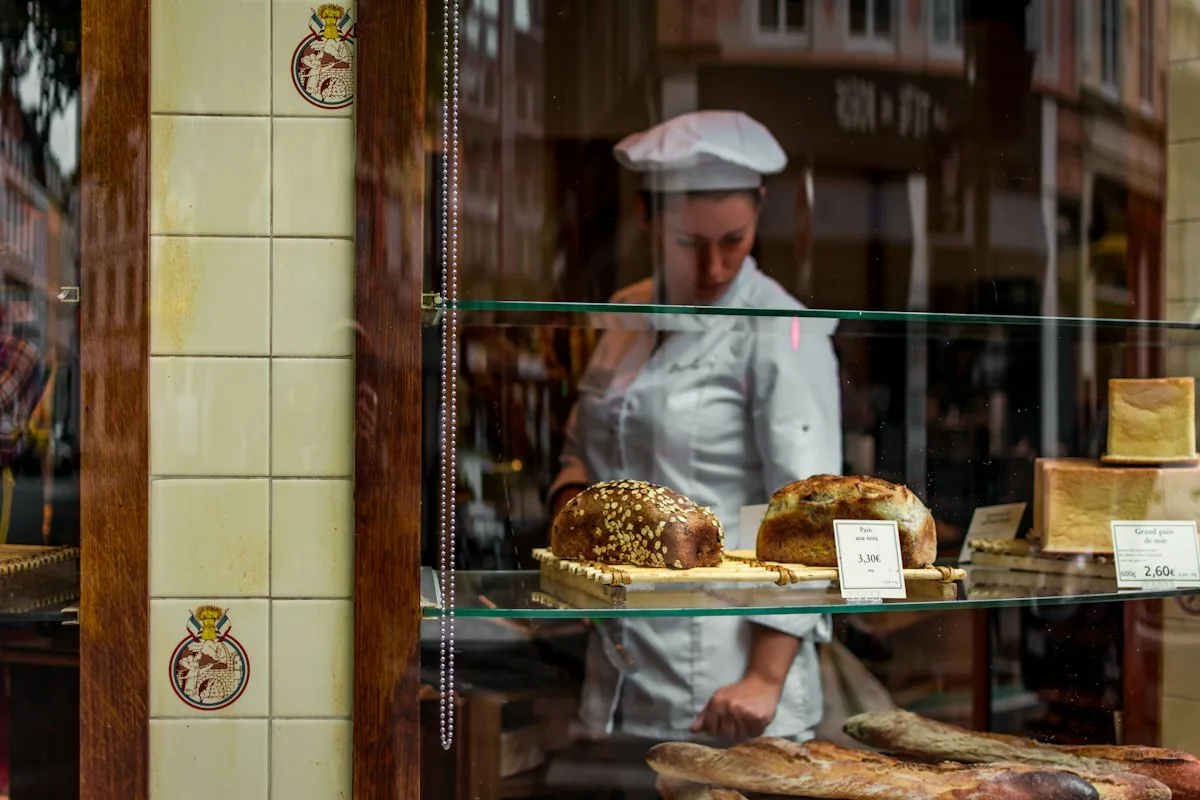 Baker working behind a bread display